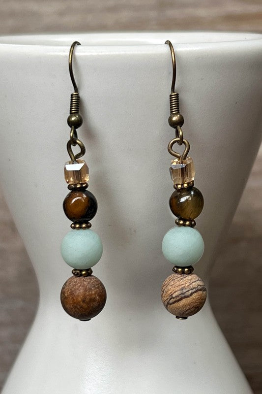 Add a pop of color and style to any outfit with our Emory Earrings! These playful fishhook dangles feature four unique Amazonite beads, adding a touch of whimsy to your look. With a length of 2 inches, these earrings are the perfect addition to any jewelry collection.