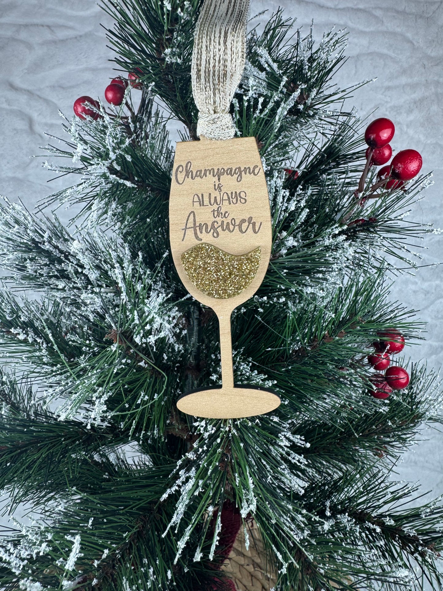 Champagne glass ornament with 'Champagne is always the answer'