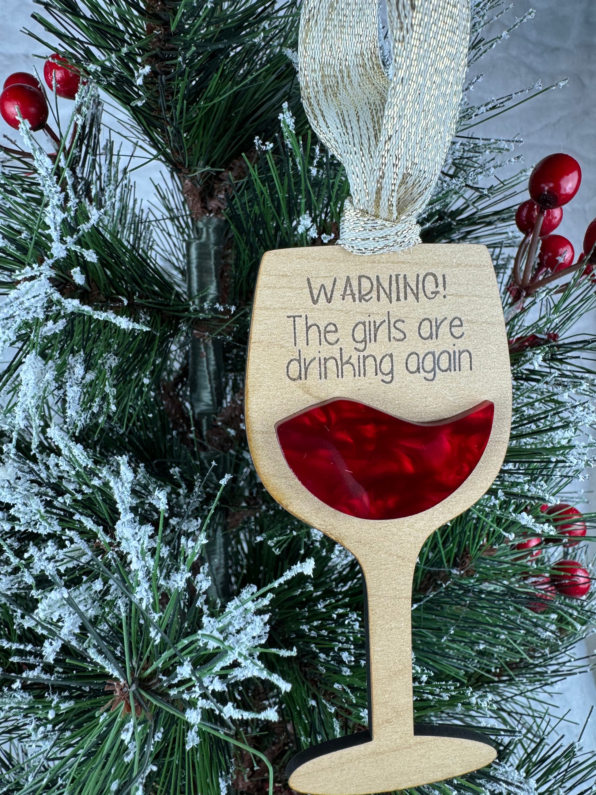 Wine glass ornament with 'Warning! The girls are drinking again'