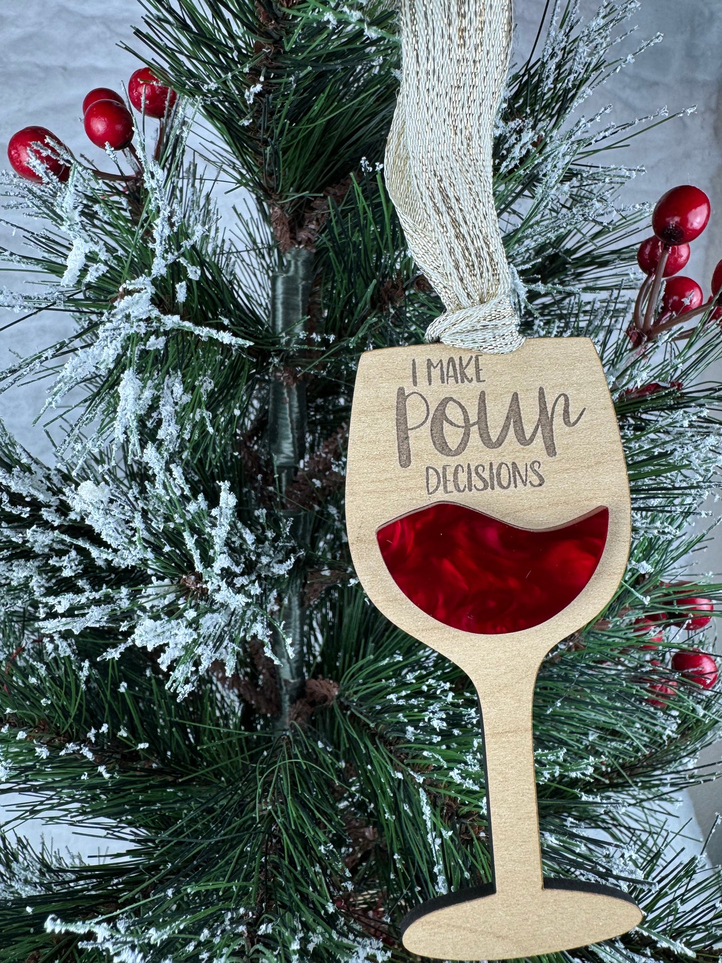 Wine glass ornament with 'I make pour decisions'