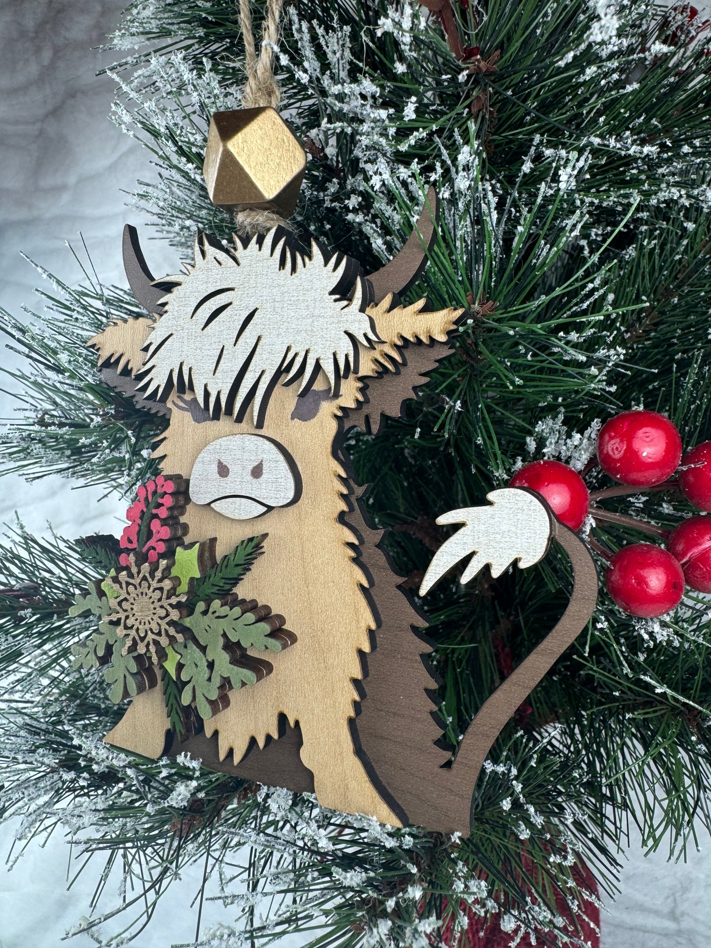 Highland Cow ornament hanging on decorated tree