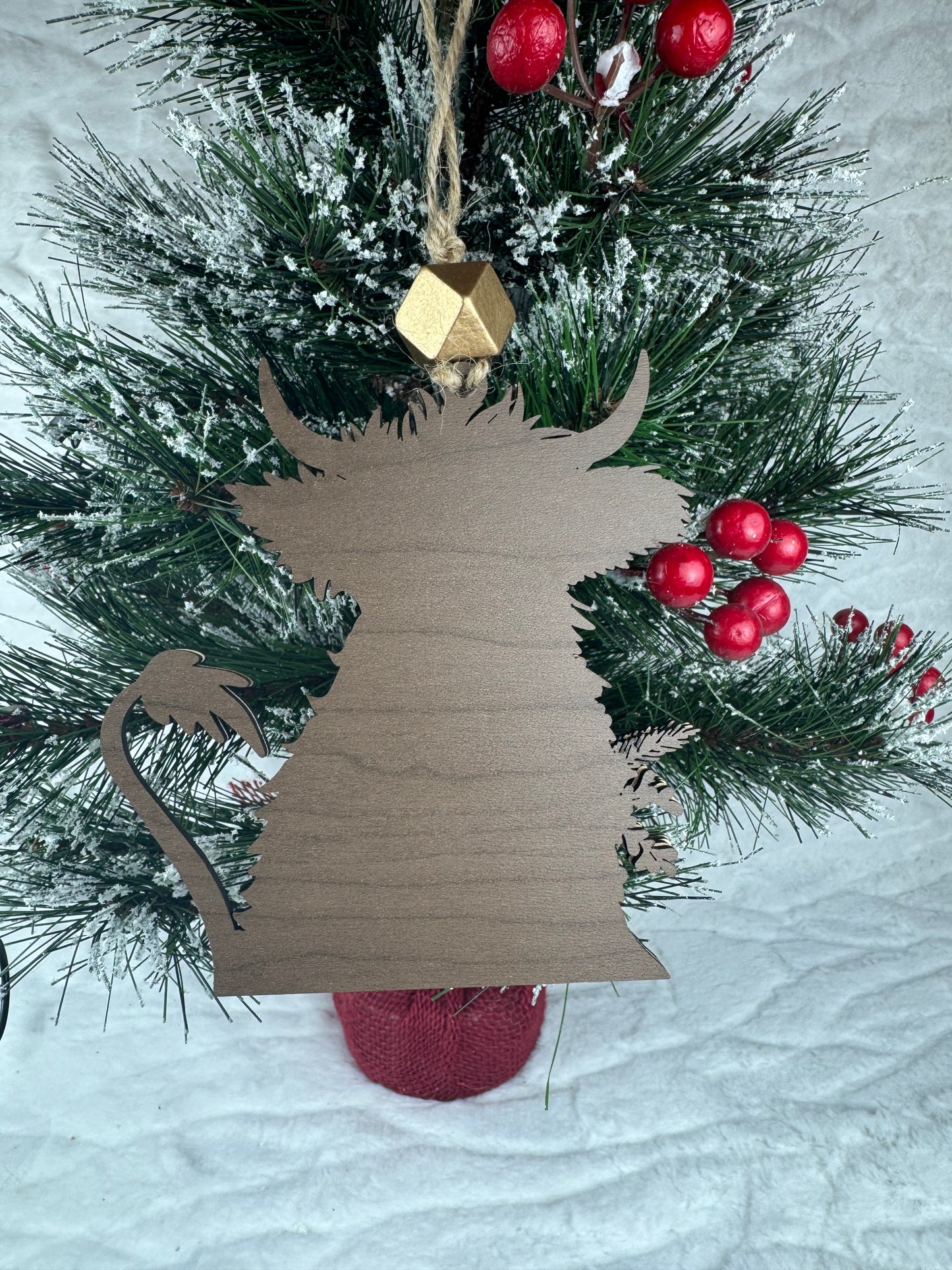 Back view of Highland Cow ornament on tree