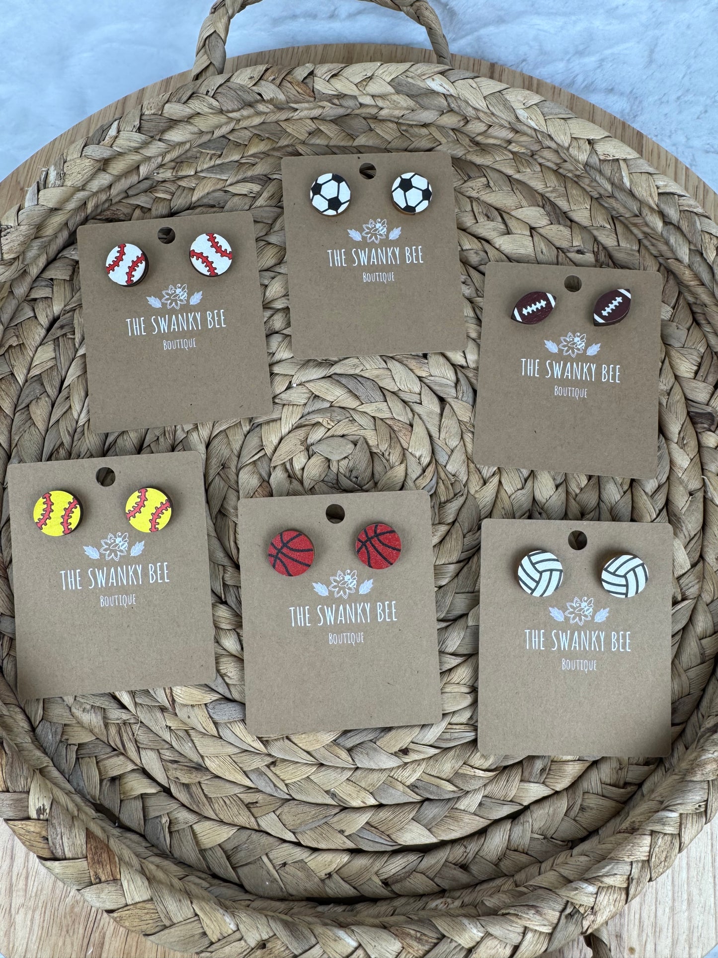 Assorted sports studs earrings on display cards