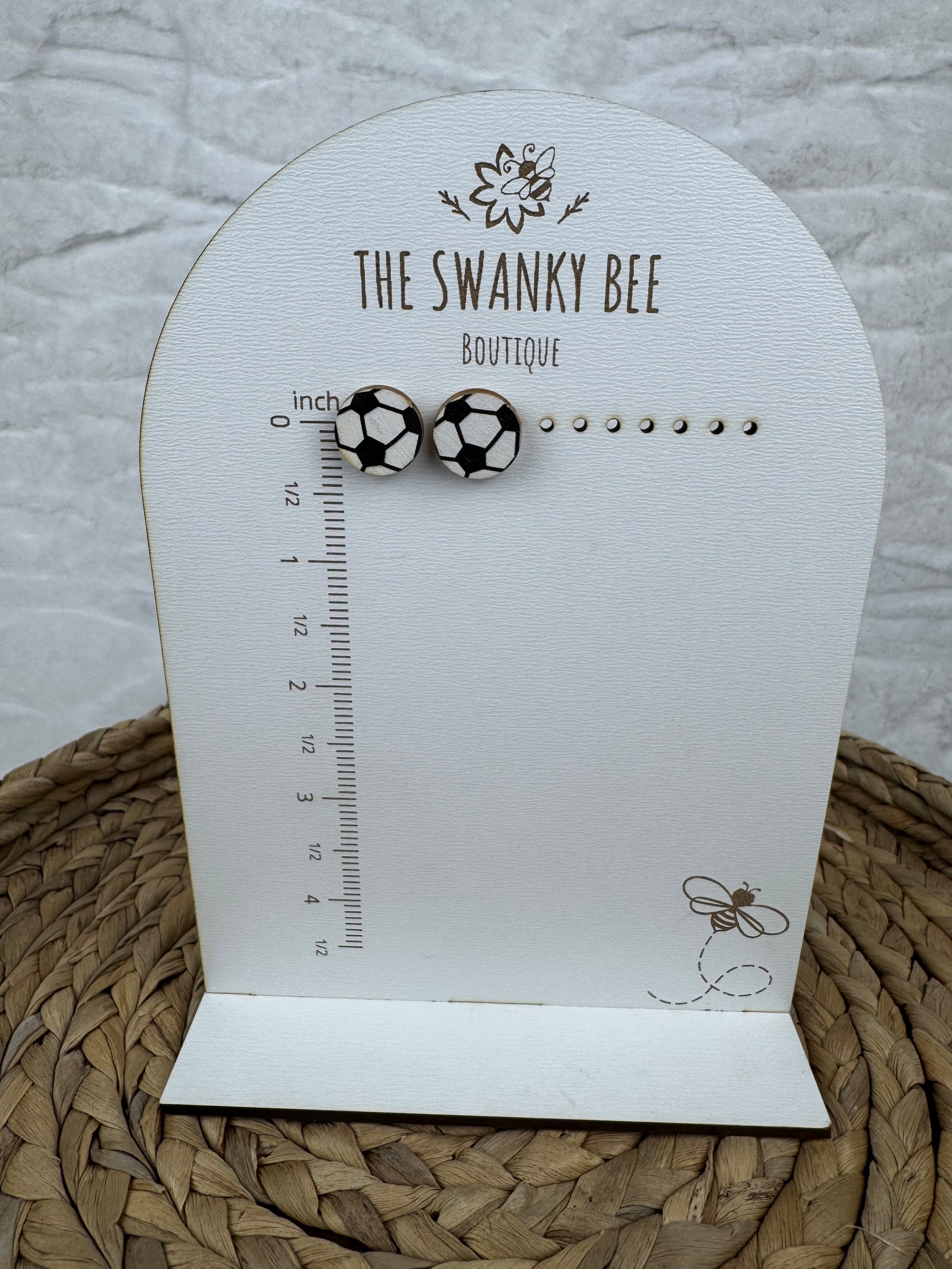 Soccer studs earrings on measurement card